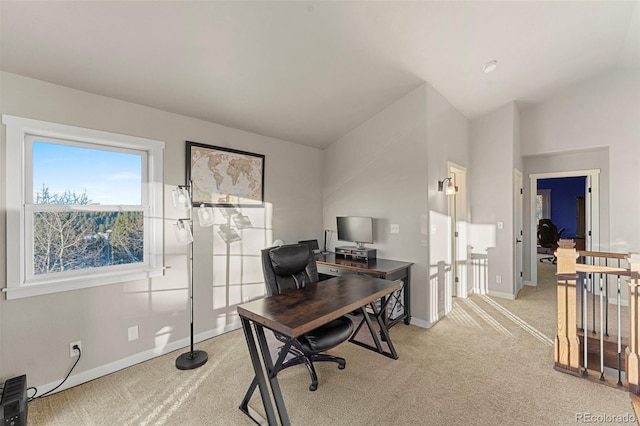 office featuring light carpet and vaulted ceiling