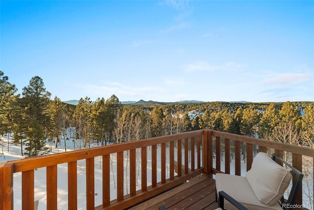 snow covered deck featuring a mountain view