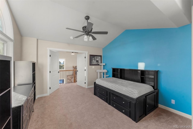 carpeted bedroom featuring multiple windows, lofted ceiling, and ceiling fan