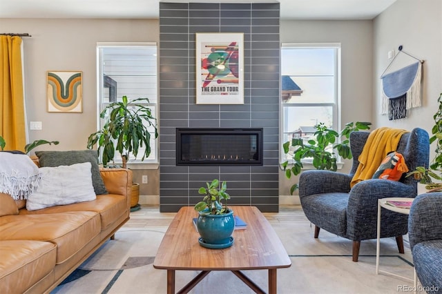 living room featuring a tile fireplace