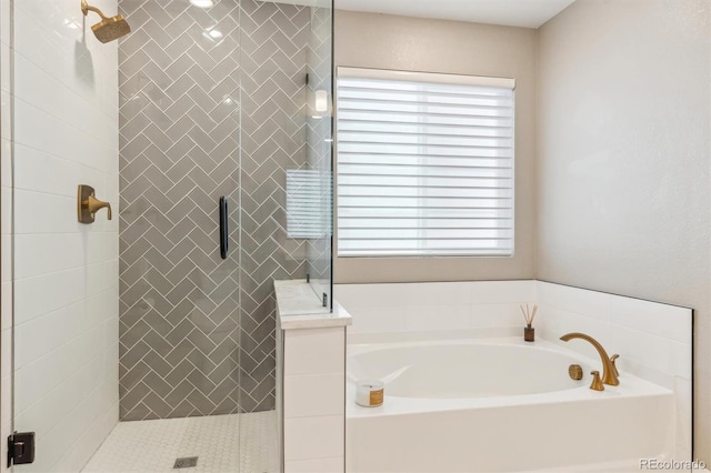 bathroom featuring a shower stall, a bath, and a healthy amount of sunlight