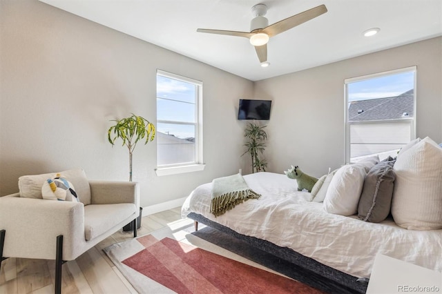 bedroom with wood finished floors, ceiling fan, baseboards, and recessed lighting