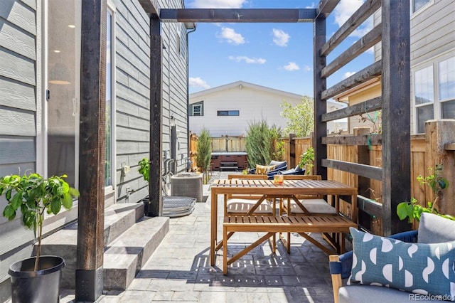view of patio / terrace featuring cooling unit, fence, and a hot tub