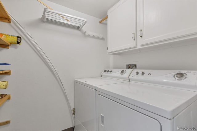 washroom with independent washer and dryer and cabinet space