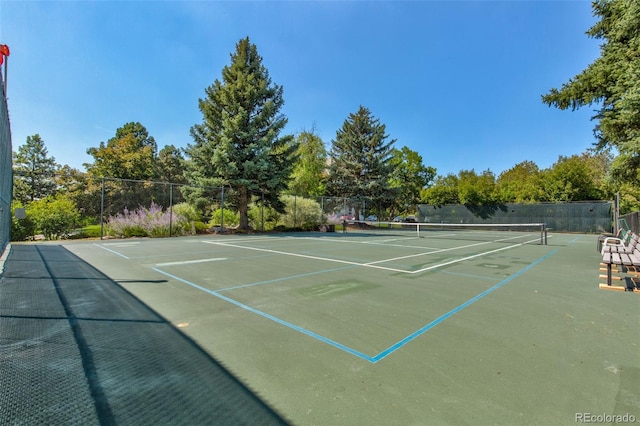 view of tennis court featuring fence