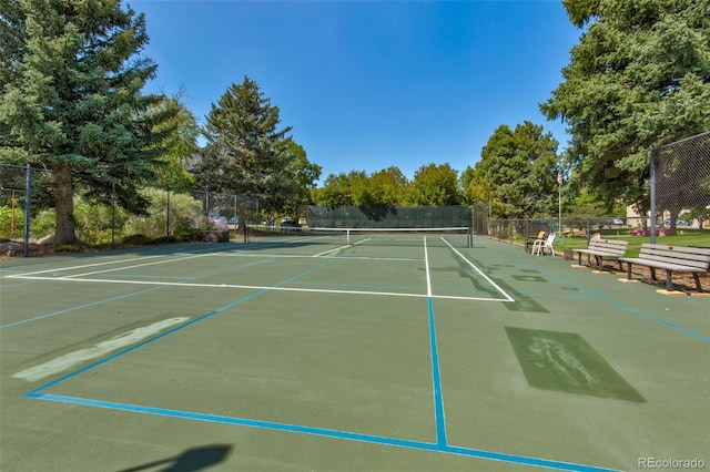 view of tennis court with fence and community basketball court