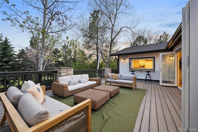 deck at dusk featuring outdoor lounge area