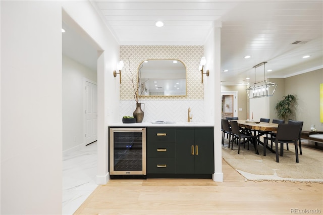 bar with wine cooler, visible vents, wet bar, crown molding, and tasteful backsplash