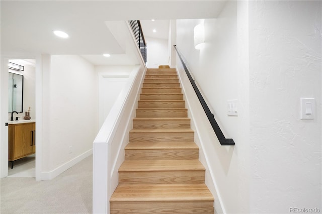 staircase featuring carpet floors, baseboards, and recessed lighting