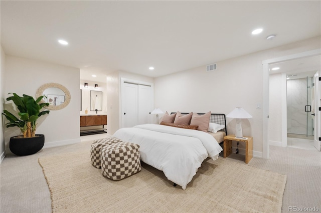 bedroom featuring ensuite bathroom, light carpet, baseboards, and recessed lighting