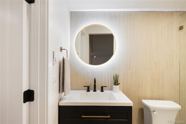 bathroom featuring toilet and vanity