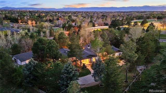 aerial view at dusk featuring a mountain view