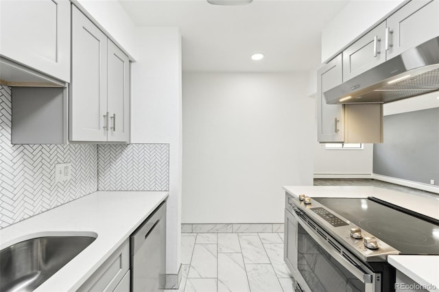 kitchen with stainless steel appliances and tasteful backsplash