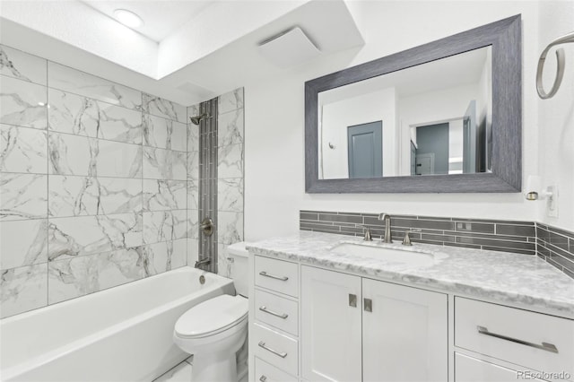 full bathroom with vanity, toilet, and tiled shower / bath