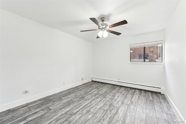 unfurnished room featuring ceiling fan, a baseboard heating unit, and light wood-type flooring