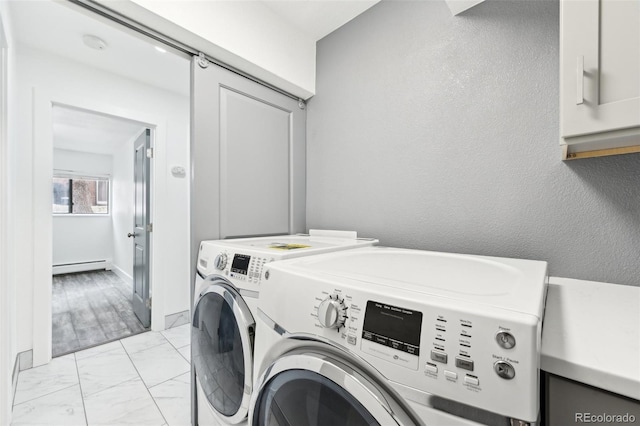 washroom with baseboard heating, independent washer and dryer, and cabinets