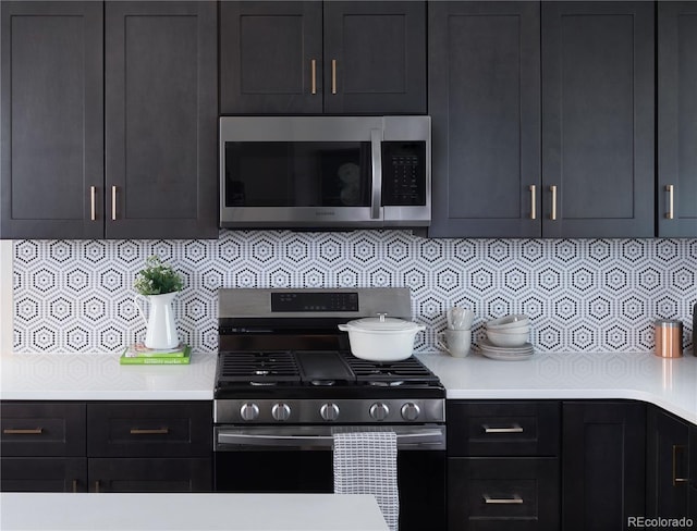11914 W 57th Dr, Arvada, CO 80002 - kitchen with appliances with stainless steel finishes, light countertops, and decorative backsplash