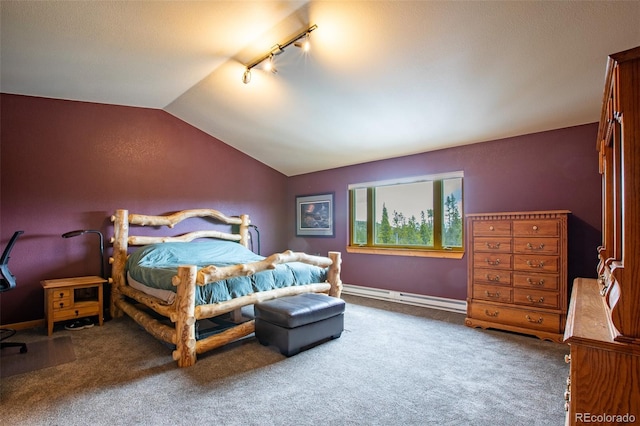 bedroom with vaulted ceiling, baseboard heating, carpet flooring, and track lighting