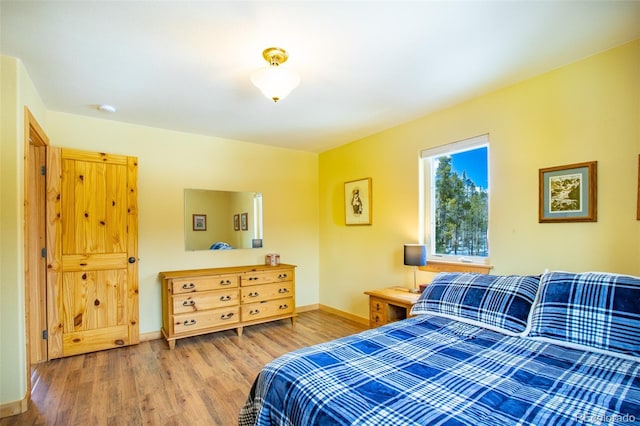 bedroom with wood finished floors and baseboards