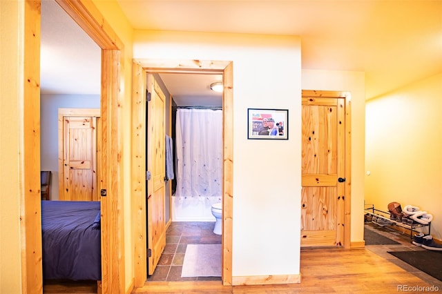 corridor featuring wood finished floors