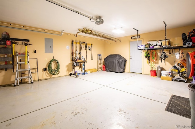 garage featuring electric panel and a garage door opener