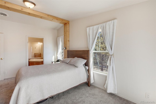 carpeted bedroom featuring lofted ceiling with beams, baseboards, visible vents, and ensuite bathroom