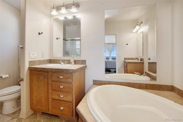 bathroom featuring a garden tub, visible vents, vanity, a shower stall, and ensuite bath