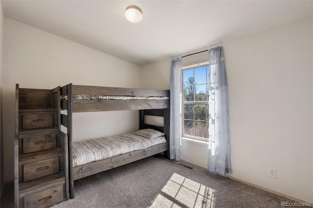 carpeted bedroom featuring visible vents and baseboards