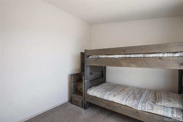 unfurnished bedroom featuring baseboards and carpet flooring