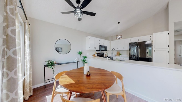 3755 Shefield Dr, Broomfield, CO 80020 - dining space with a ceiling fan, vaulted ceiling, and wood finished floors