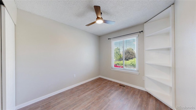3755 Shefield Dr, Broomfield, CO 80020 - spare room featuring wood finished floors, a textured ceiling, and a ceiling fan