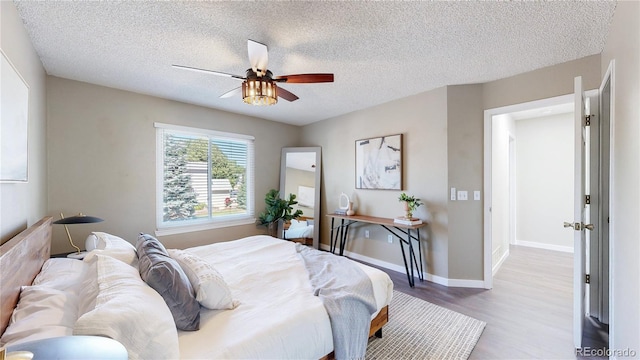 3755 Shefield Dr, Broomfield, CO 80020 - bedroom featuring wood finished floors, a textured ceiling, and ceiling fan