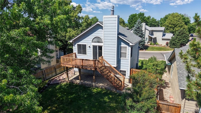 3755 Shefield Dr, Broomfield, CO 80020 - back of property featuring stairway, a fenced backyard, a wooden deck, and a chimney