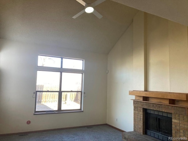 unfurnished living room with a fireplace, a wealth of natural light, carpet floors, and ceiling fan