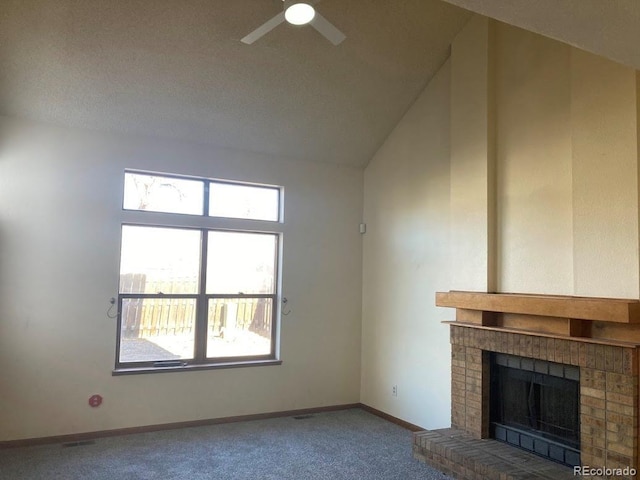 unfurnished living room featuring ceiling fan, a fireplace, carpet floors, and plenty of natural light