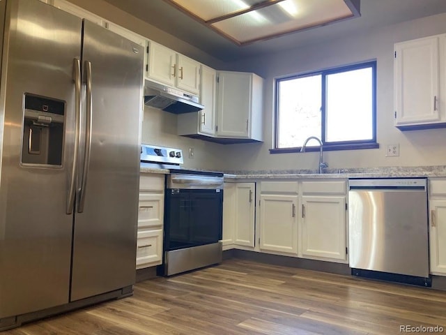 kitchen featuring white cabinetry, sink, hardwood / wood-style floors, and appliances with stainless steel finishes