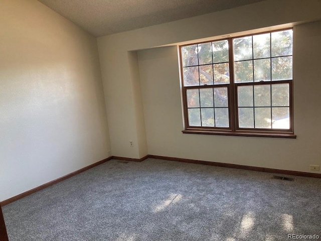 spare room with a textured ceiling