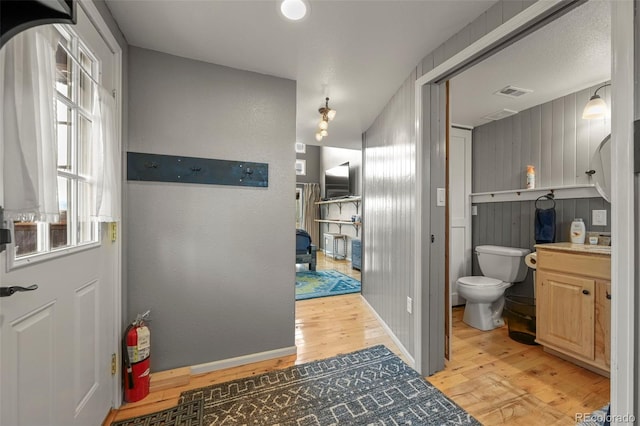 bathroom with hardwood / wood-style flooring and toilet