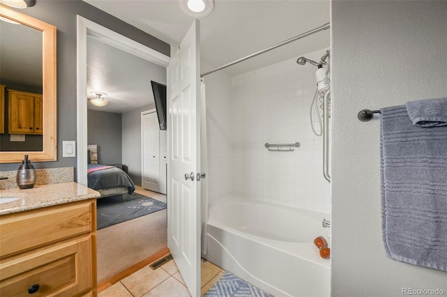 bathroom featuring tile patterned flooring, vanity, and shower / bath combo