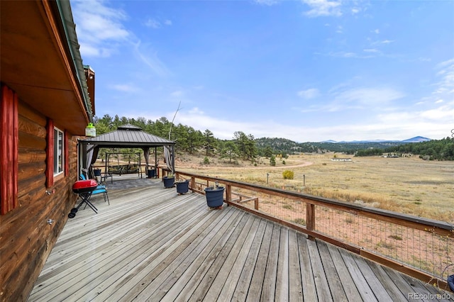 deck with a gazebo and a rural view