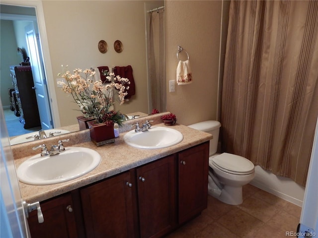 7354 Benton St, Arvada, CO 80003 - full bathroom with double vanity, toilet, curtained shower, and tile patterned flooring