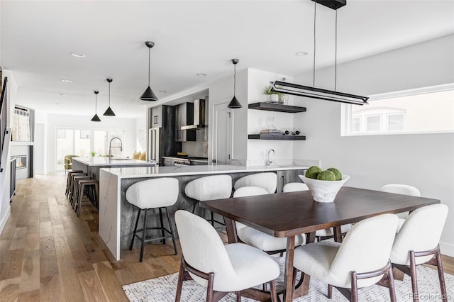 dining space featuring light hardwood / wood-style flooring and sink