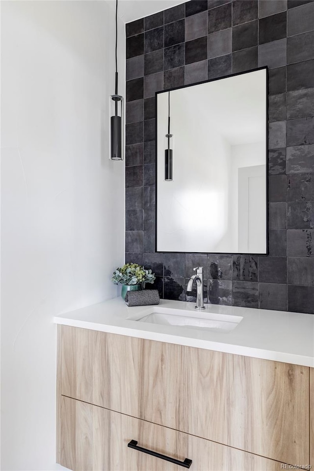 bathroom with vanity and decorative backsplash