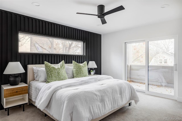 bedroom featuring ceiling fan, carpet floors, access to outside, and multiple windows