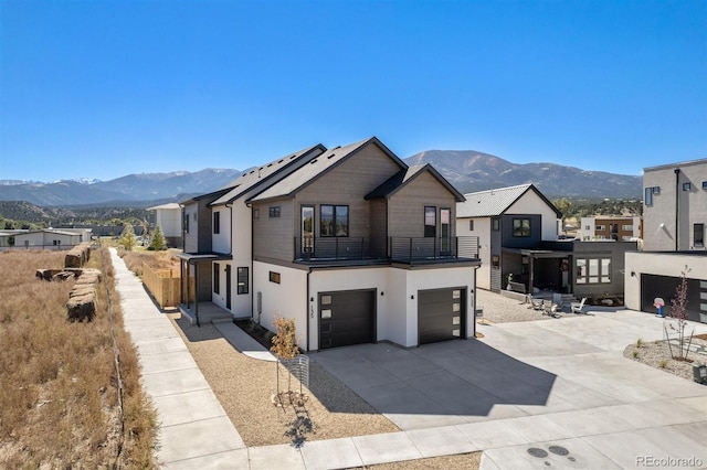 view of front of house with a balcony, a mountain view, and a garage