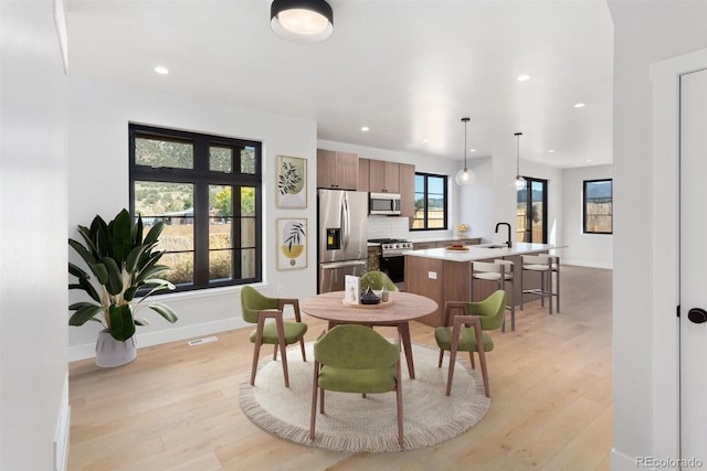 dining area featuring light hardwood / wood-style floors and sink