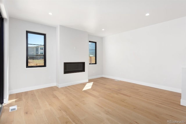 unfurnished living room featuring light wood-type flooring