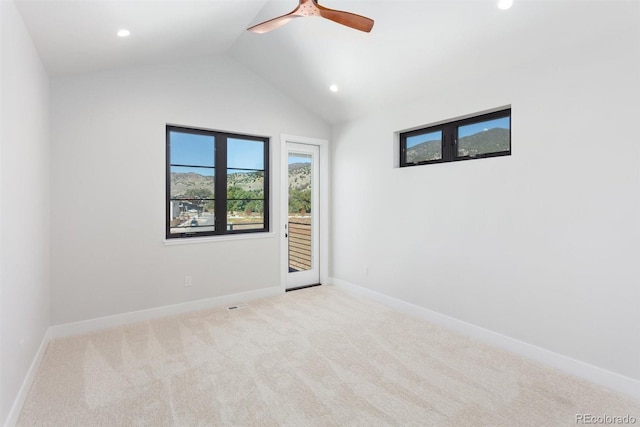 unfurnished room with vaulted ceiling, ceiling fan, and light colored carpet