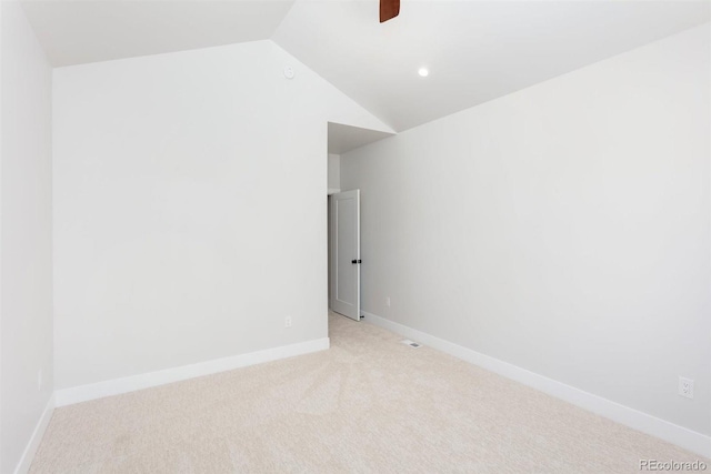 carpeted empty room featuring lofted ceiling