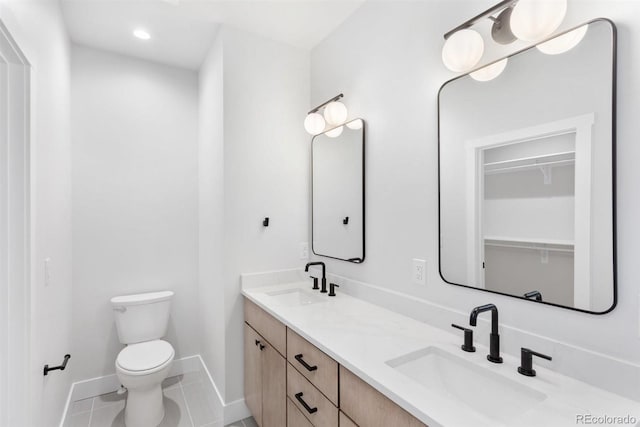 bathroom with vanity, tile patterned flooring, and toilet